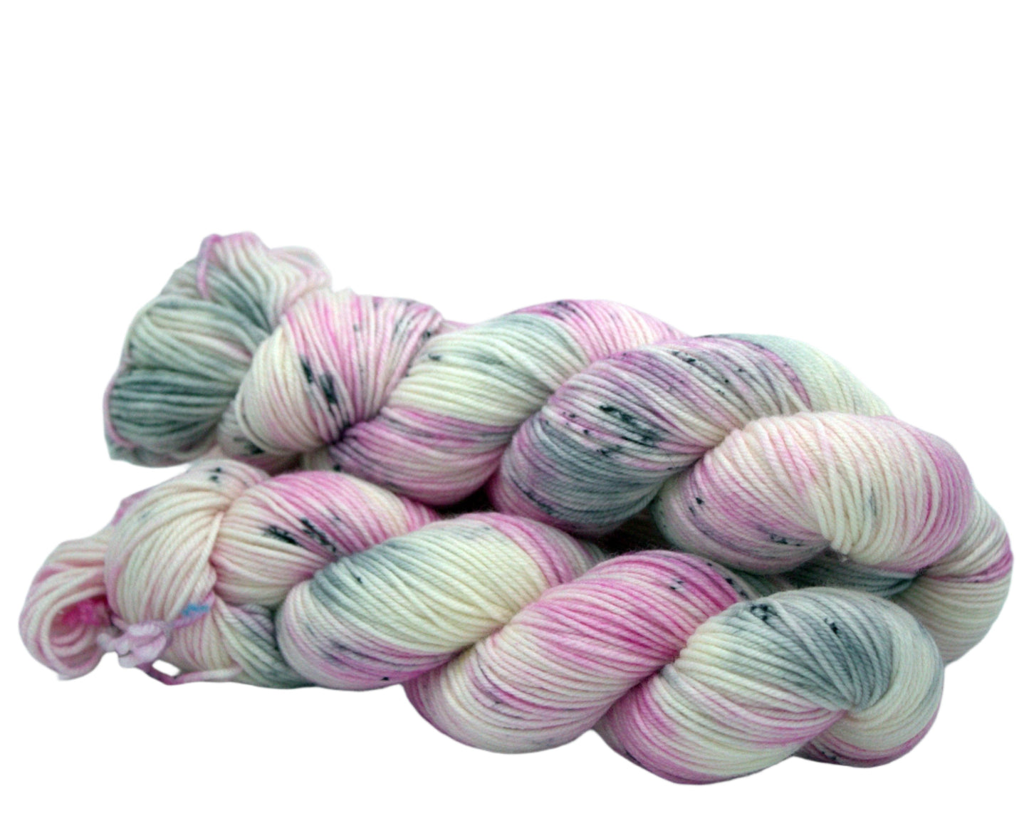 side view of three twisted skeins of pink, white and gray yarn with dark grey speckles on white background.