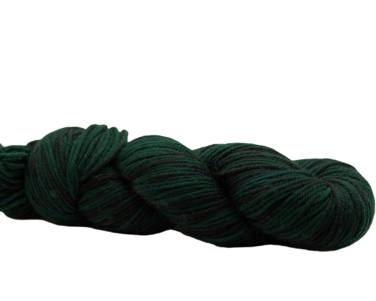 side view of variegated dark green and black yarn on white background.