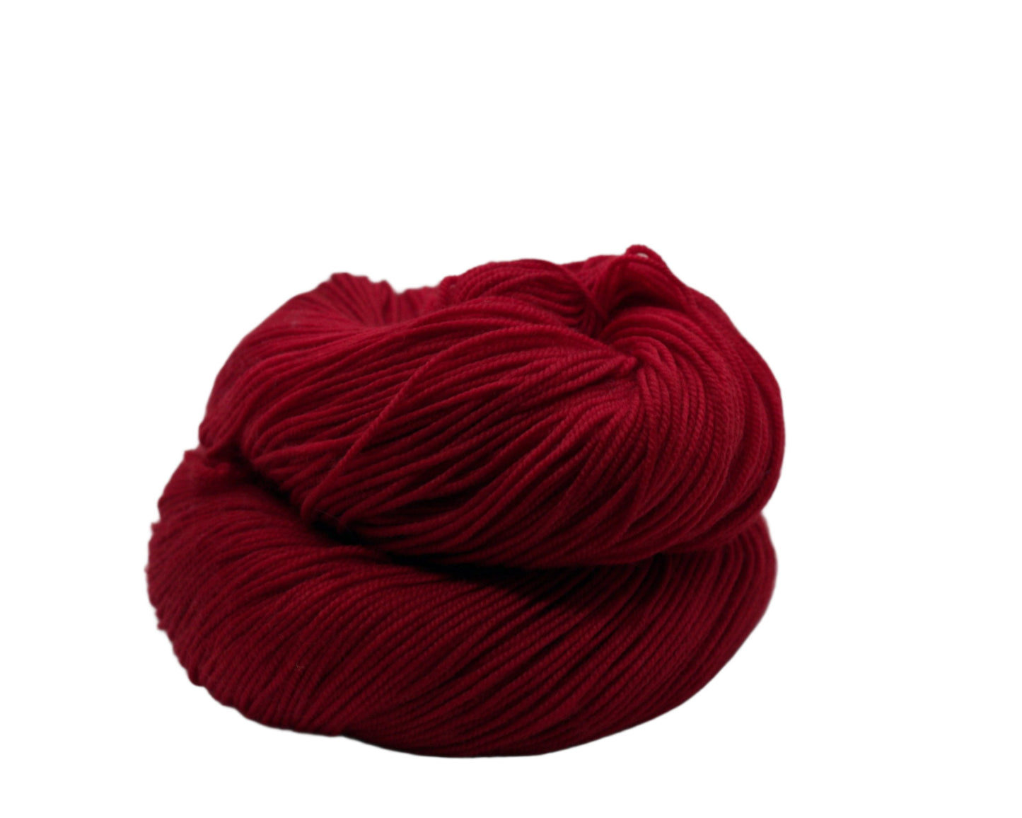 one curled skein of lipstick red colored yarn on white background.