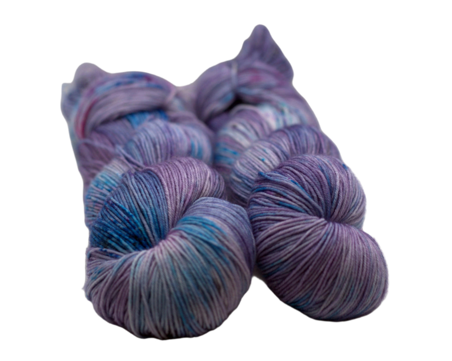two twisted skeins light purple yarn with turquoise, magenta and black speckles on white background.