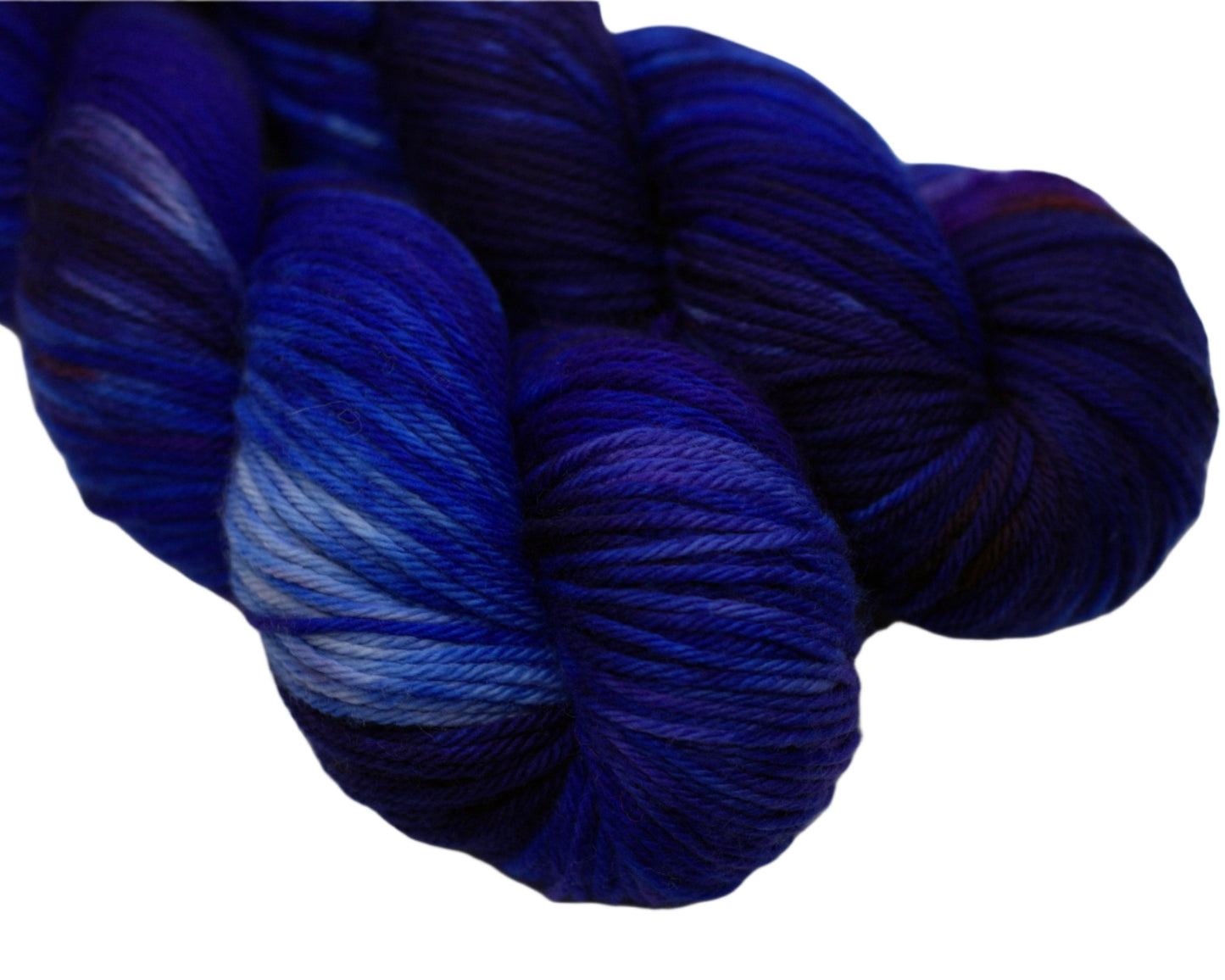 Close up of two twisted skeins of variegated blue, white and red yarn on white background.