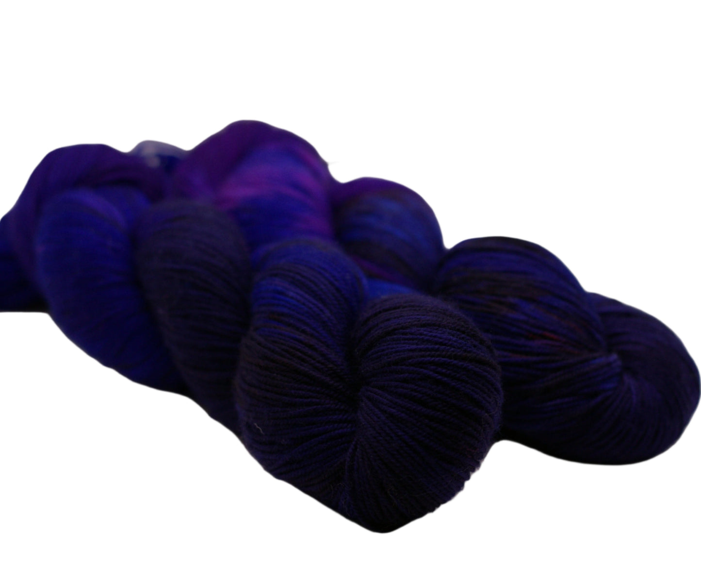 two twisted skeins of blue layered over red yarn on white background.