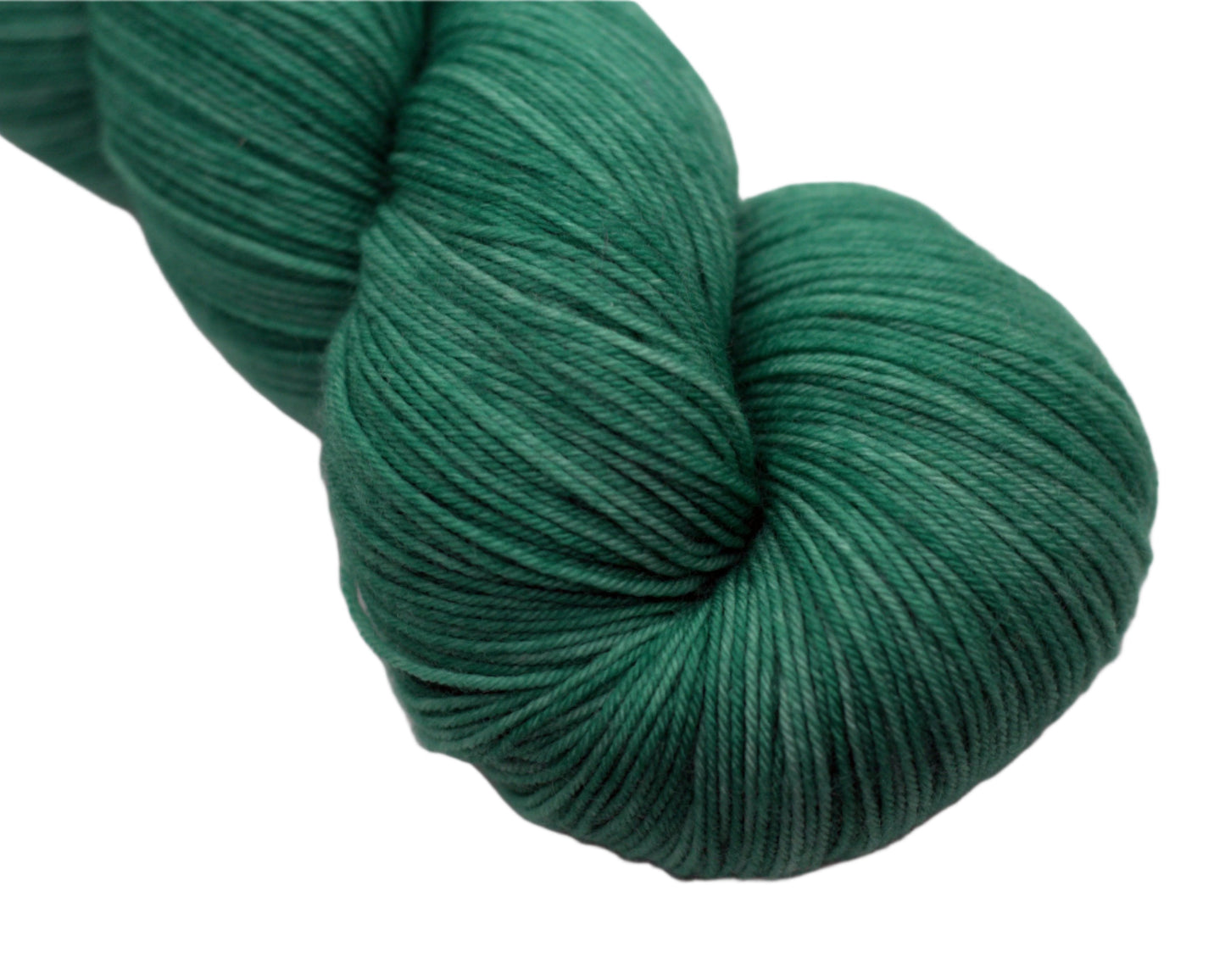 Close up of a the top portion of a twisted skein of green yarn on a white background