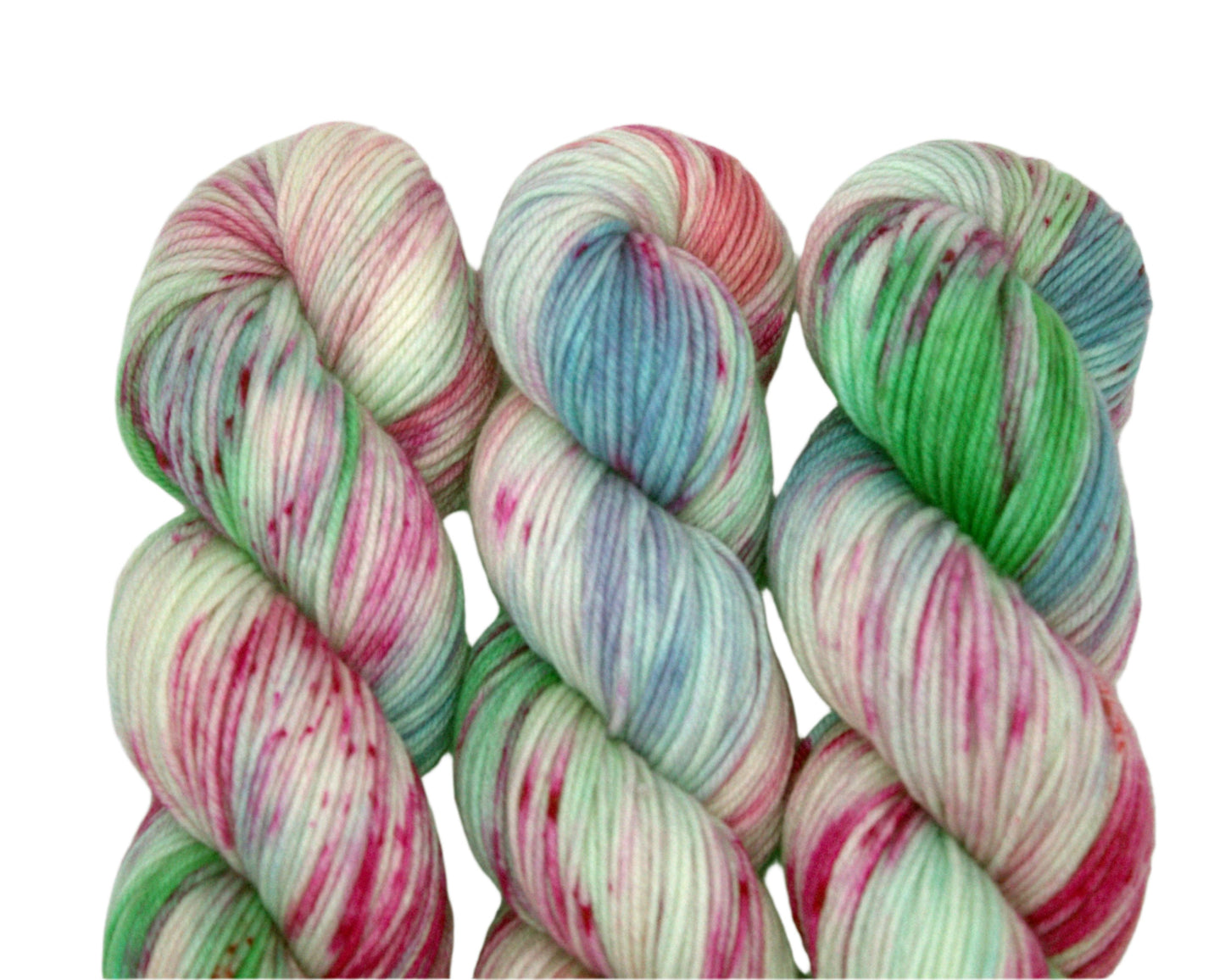 three twisted skeins of pink, blue and green speckled yarn on white background.