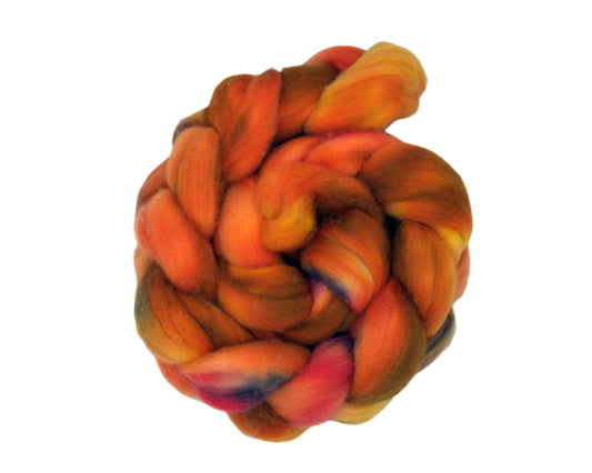 top view of braided combed top in autumn colors of orange, red, yellow and deep purple on white background.