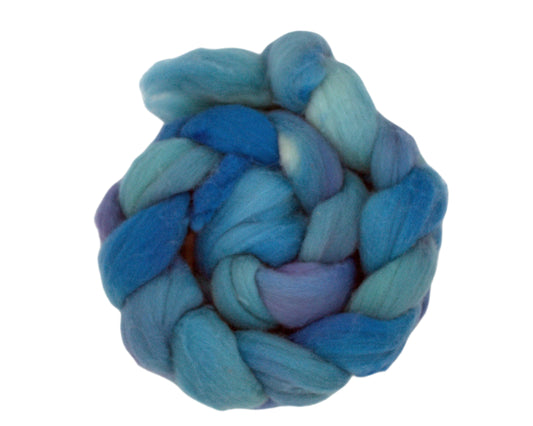 top view of braided combed top in blues and purples on white background.