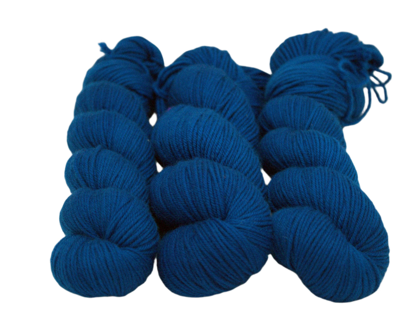 three twisted skeins peacock blue yarn on white background.