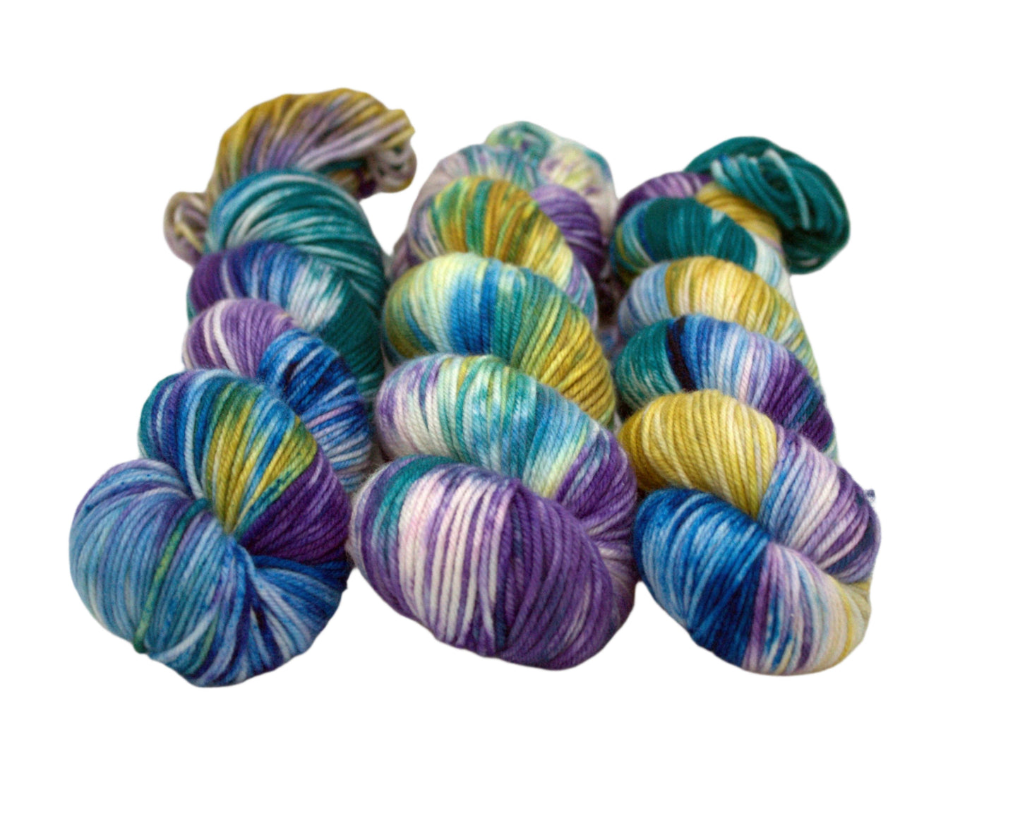 three twisted skeins variegated blue, purple, teal, gold and white yarn on white background.