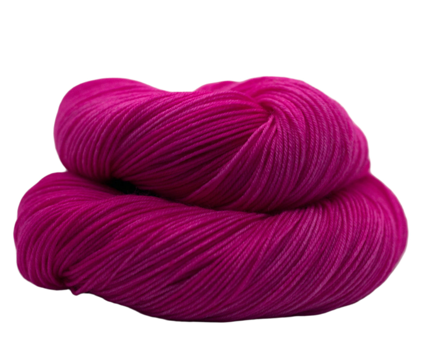 one curled up skein tonal bright pink yarn on white background.