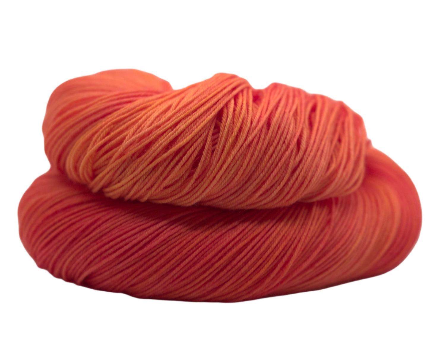 One curled skein of orange yarn with yellow undertones on white background.