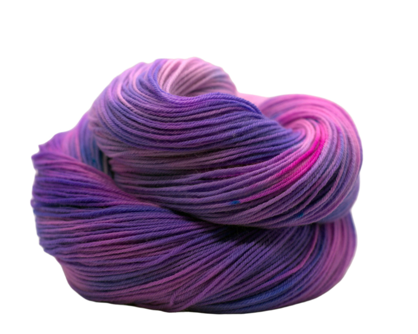 One curled up skein of pink, purple and blue variegated yarn on a white background