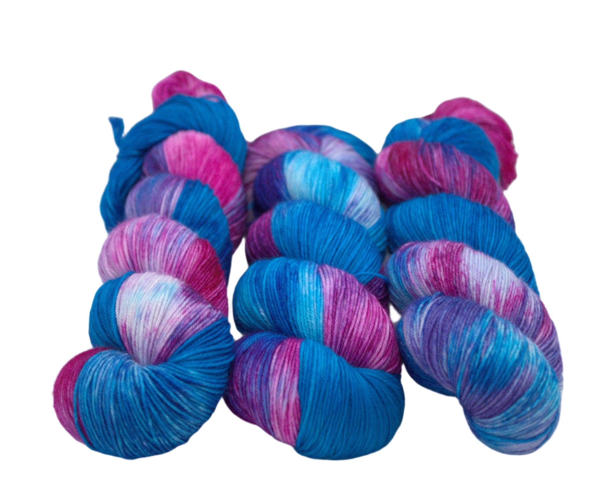 Three twisted skeins of turquoise, magenta, and purple variegated yarn on a white background.