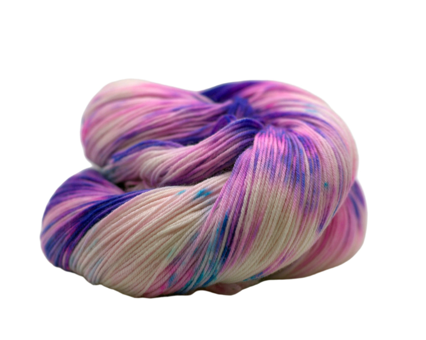 One skein of curled up purple, pink and aqua colored yarn on a white background.