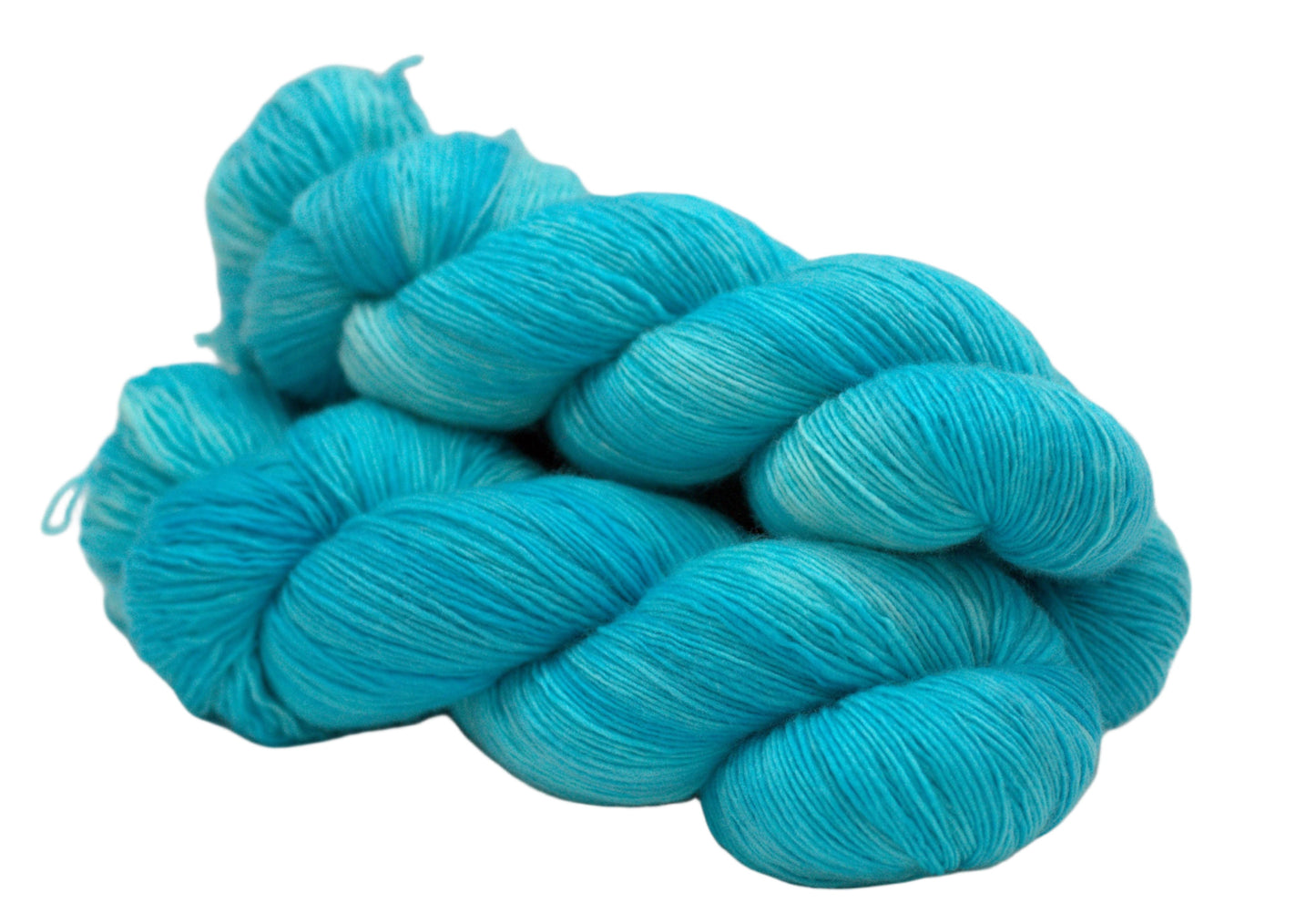 side view of three twisted skeins tonal turquoise yarn on white background.