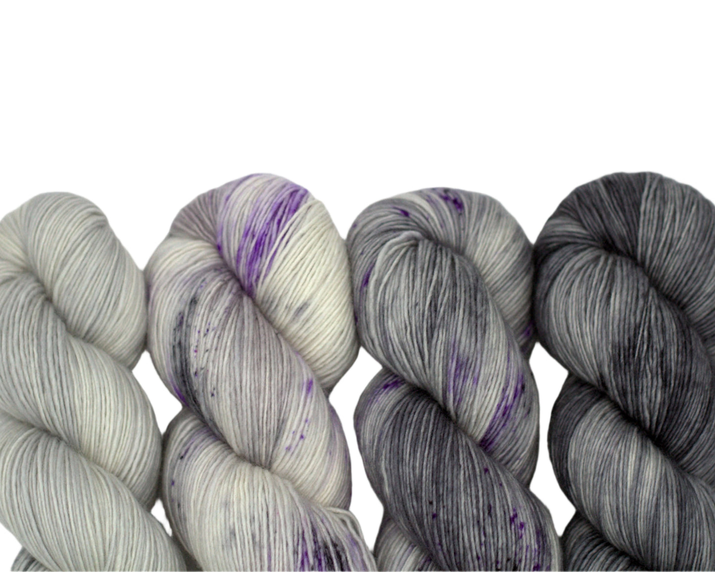 four twisted skeins color coordinated silver yarn on white background.