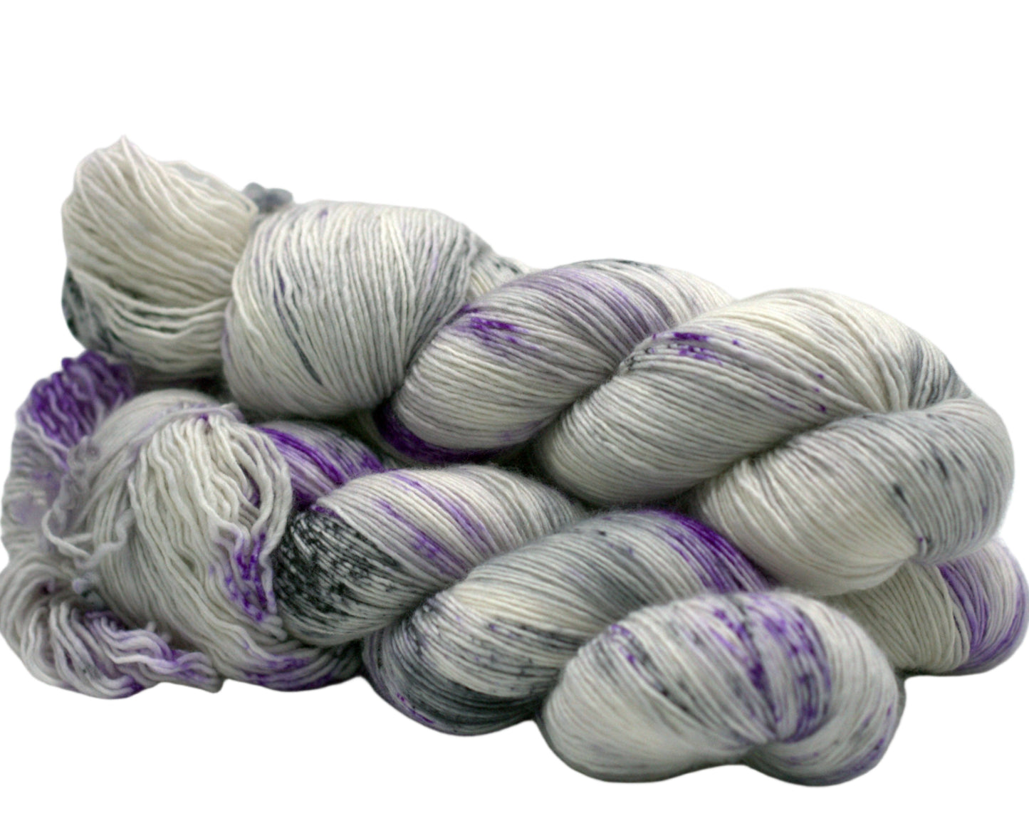 side view of three twisted skeins tonal silver yarn with purple and dark gray speckles on white background.