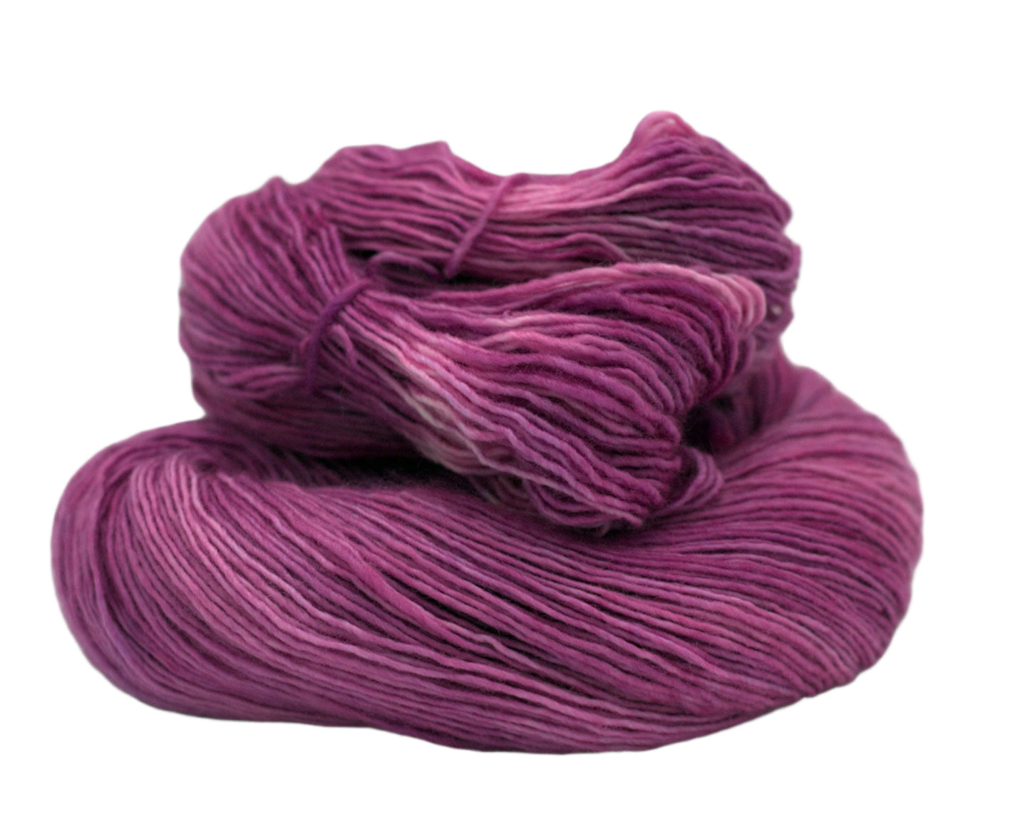 One curled skein of tonal orchid colored yarn on white background.