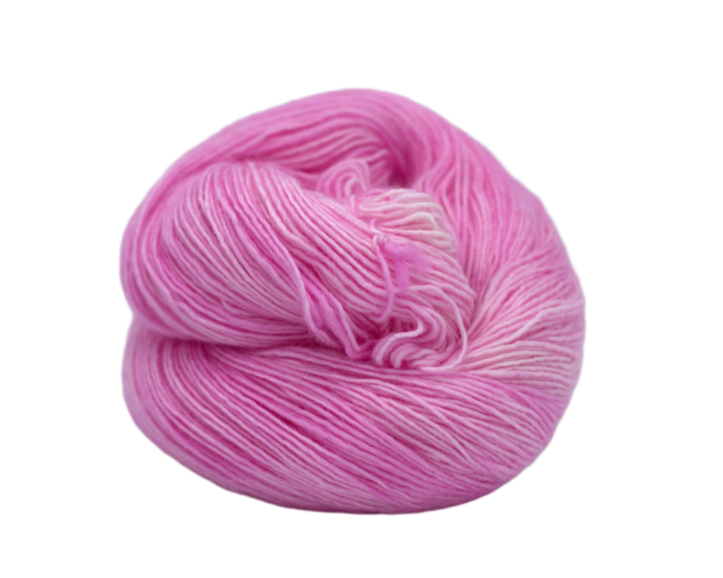 one curled skein of tonal light pink yarn on white background.