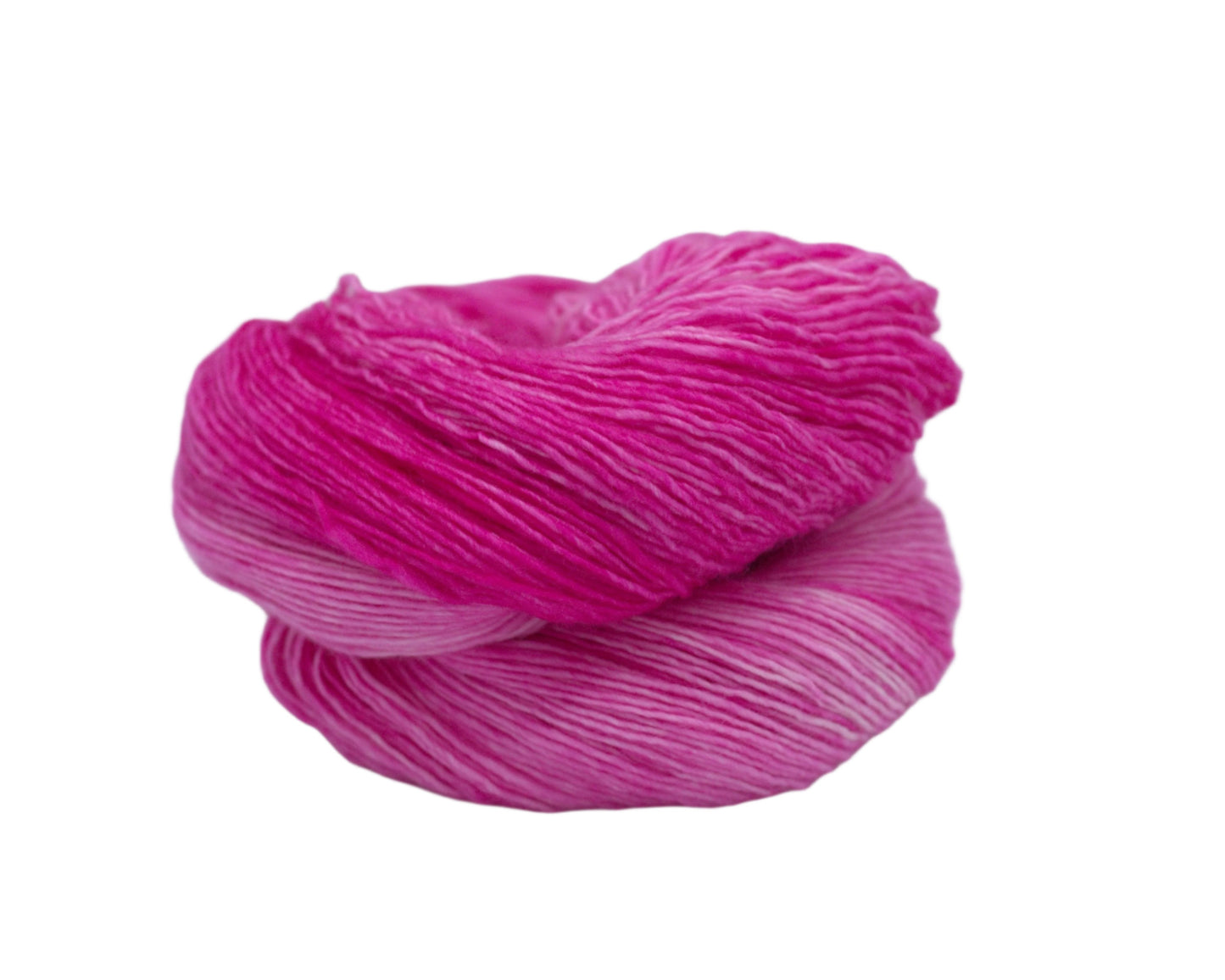 one curled skein of tonal magenta colored yarn on white background.