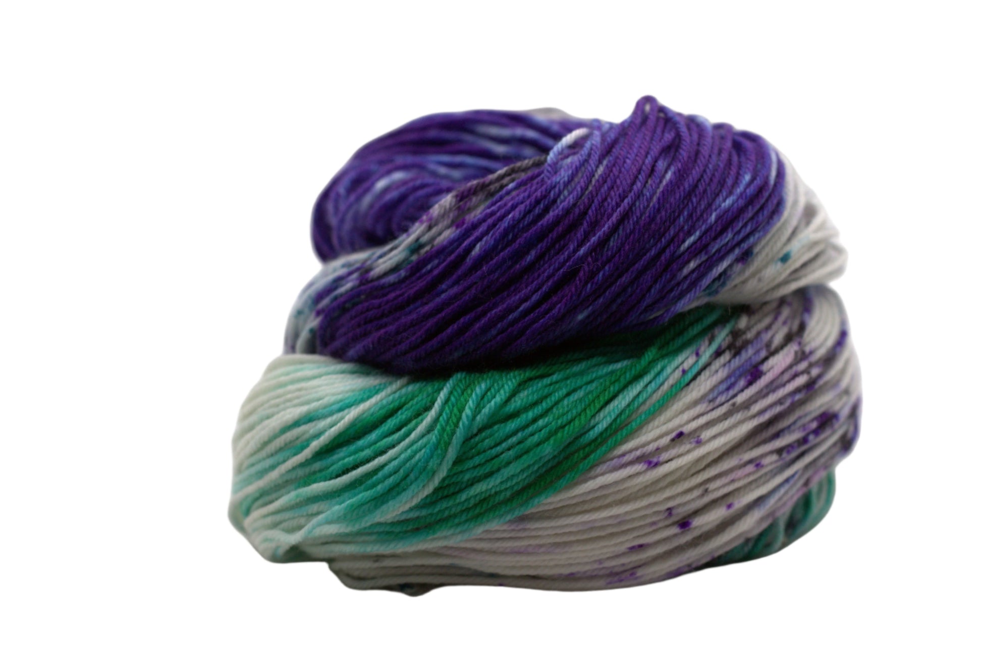 curled up skein variegated white, purple and green yarn with purple and black speckles on white background.