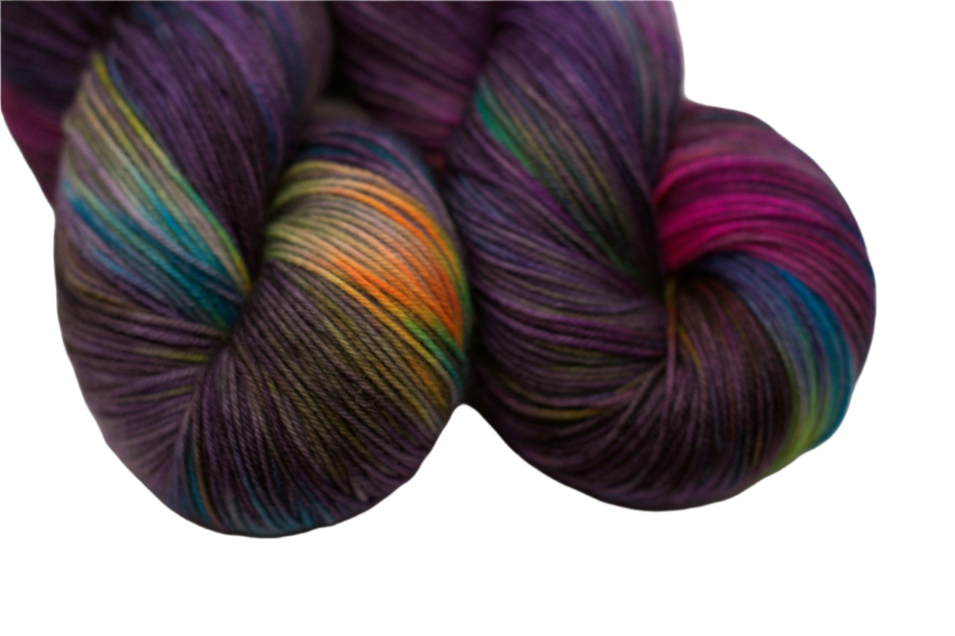 close up of two twisted skeins variegated dark purple yarn with neon colors on white background.